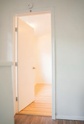 a view of a room with wooden floor