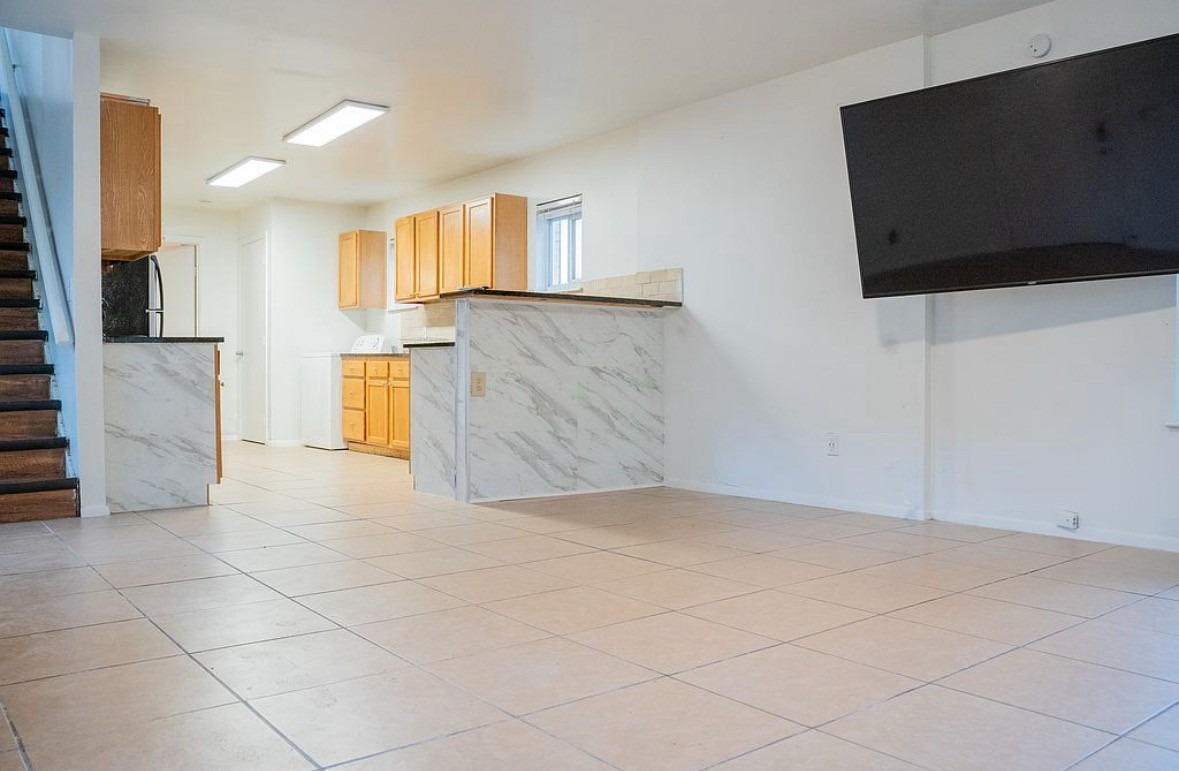 2841 San Gabriel Street Austin, TX 78705 - Photo 19 of 25 Unfurnished living room with light tile patterned floors and washer / clothes dryer