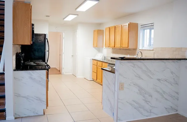 a kitchen with stainless steel appliances granite countertop a sink and a stove
