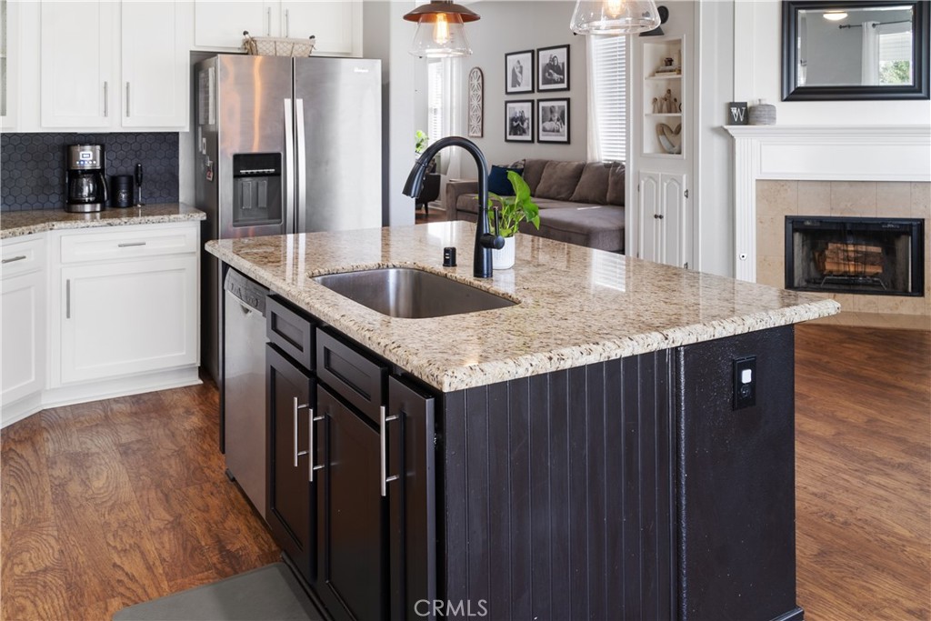20808 Millbrook Street Riverside, CA 92508 - Photo 25 of 51 a kitchen with stainless steel appliances granite countertop a sink dishwasher a refrigerator and a stove with wooden floors