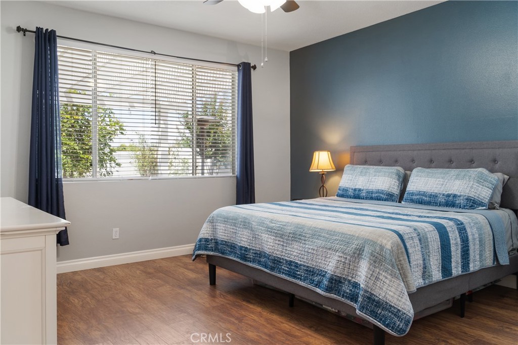 20808 Millbrook Street Riverside, CA 92508 - Photo 27 of 51 a bedroom with a bed lamp and window