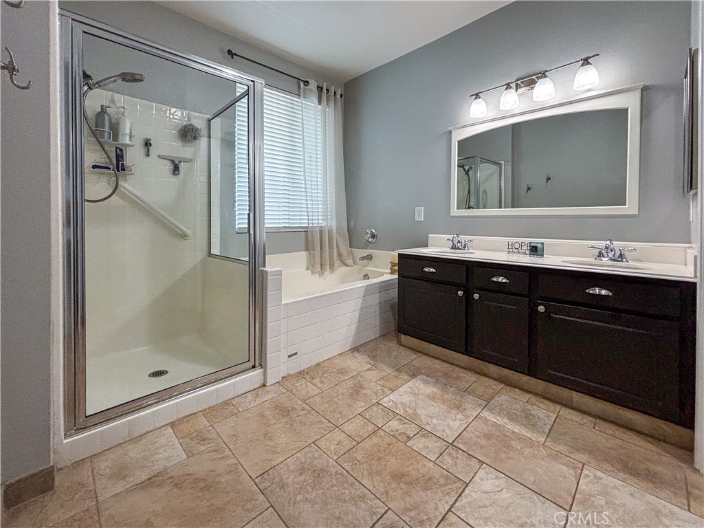 20808 Millbrook Street Riverside, CA 92508 - Photo 30 of 51 a spacious bathroom with a tub sink shower and mirror