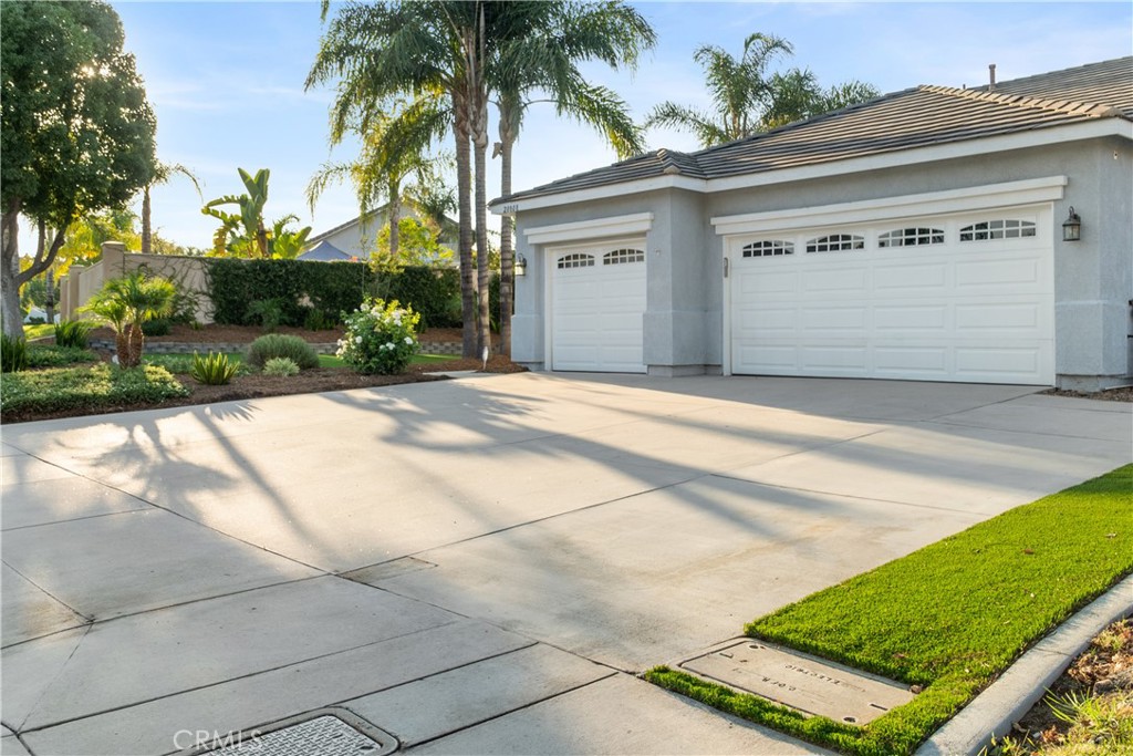 20808 Millbrook Street Riverside, CA 92508 - Photo 3 of 51 a front view of a house with a yard and a garage