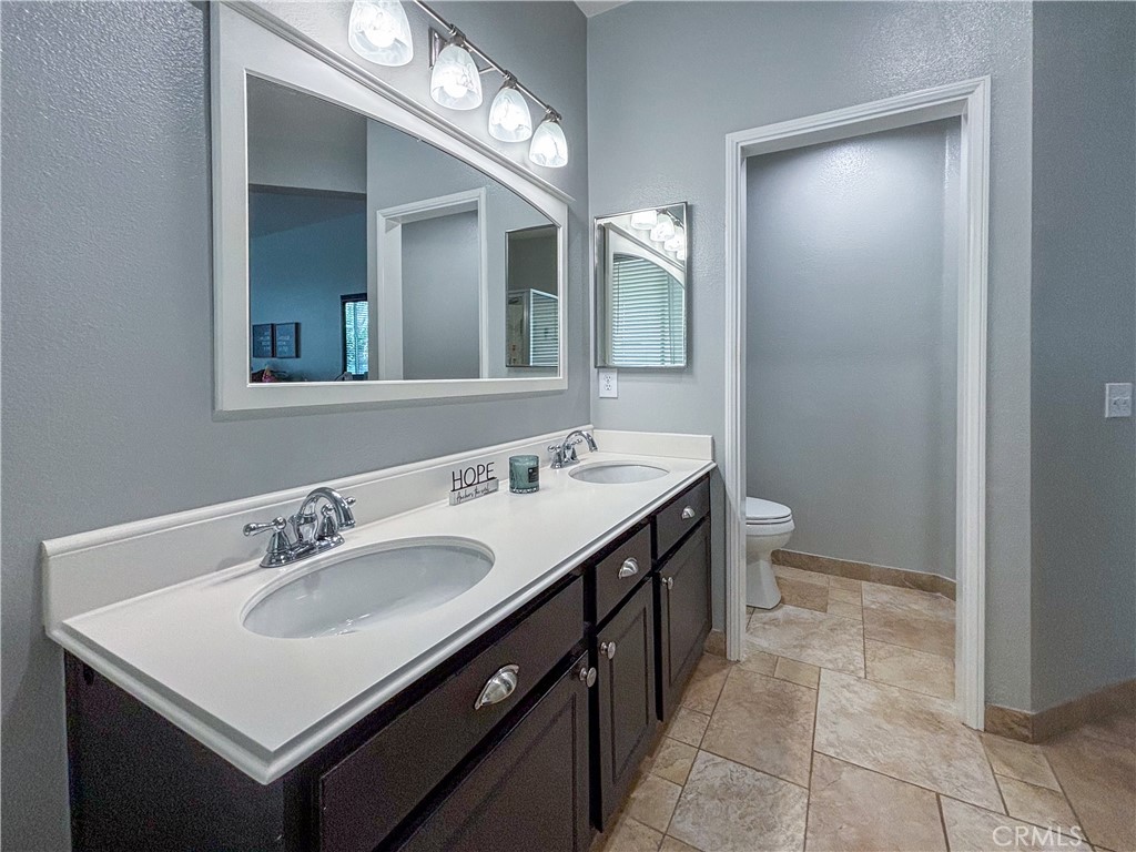20808 Millbrook Street Riverside, CA 92508 - Photo 31 of 51 a bathroom with a sink and a mirror