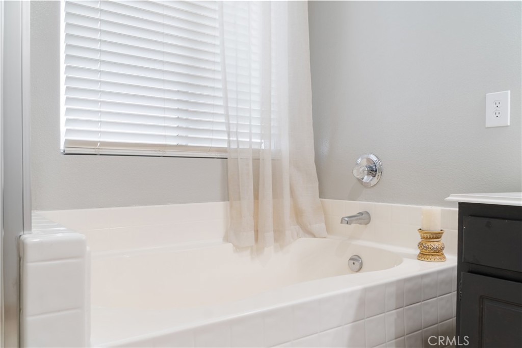 20808 Millbrook Street Riverside, CA 92508 - Photo 33 of 51 a white bath tub sitting next to a white sink