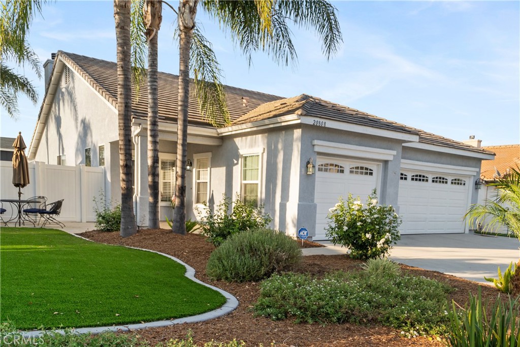20808 Millbrook Street Riverside, CA 92508 - Photo 4 of 51 a front view of a house with a garden