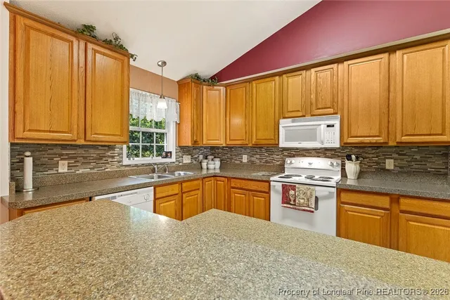 a kitchen with stainless steel appliances granite countertop a stove sink and cabinets