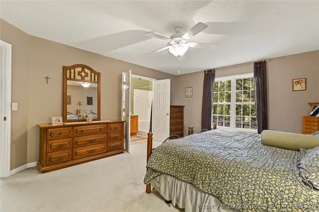 a bedroom with a bed and dresser with mirror
