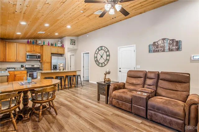 a living room with furniture a clock on wall and a clock