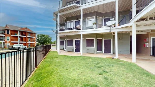 front view of a brick house with a yard