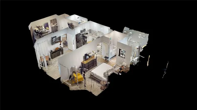 an aerial view of a house with outdoor space and sitting area