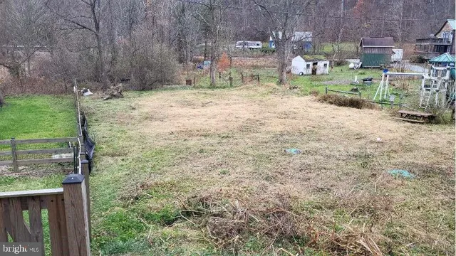a backyard of a house with barbeque oven