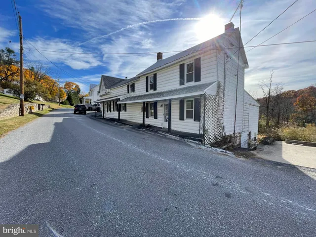 a view of a street with a building in the background