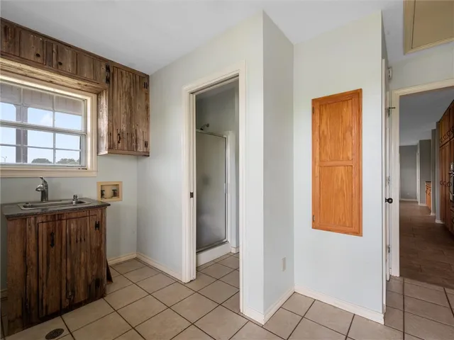 a view of a house with a big yard and large tree