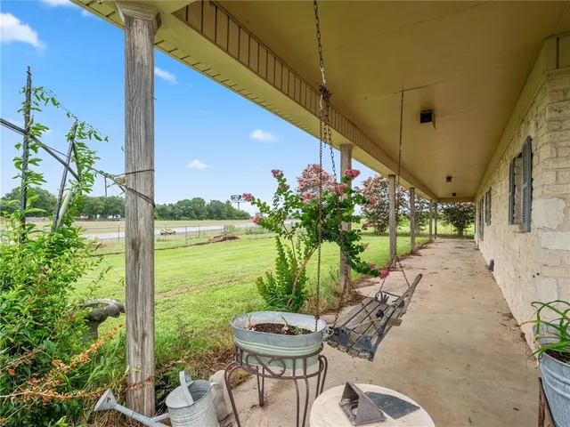a view of a chairs and table in backyard