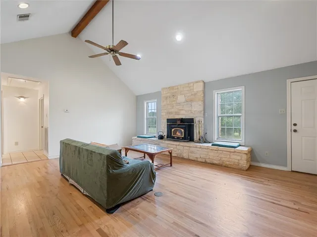 a kitchen with stainless steel appliances granite countertop a stove a sink dishwasher a refrigerator and cabinets with wooden floor