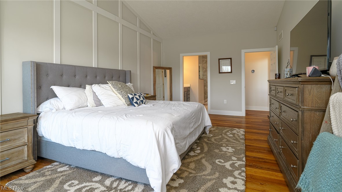 1849 Fixler Road Wadsworth, OH 44281 - Photo 12 of 39 Bedroom featuring vaulted ceiling, dark hardwood / wood-style flooring, and ensuite bathroom