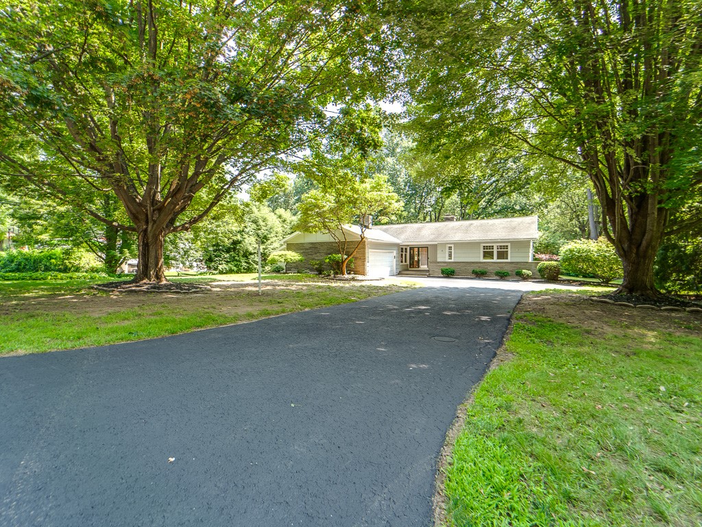 4 Tuxford Road Pittsford, NY 14534 - Photo 38 of 38 The home is canopied by lush trees creating a sere