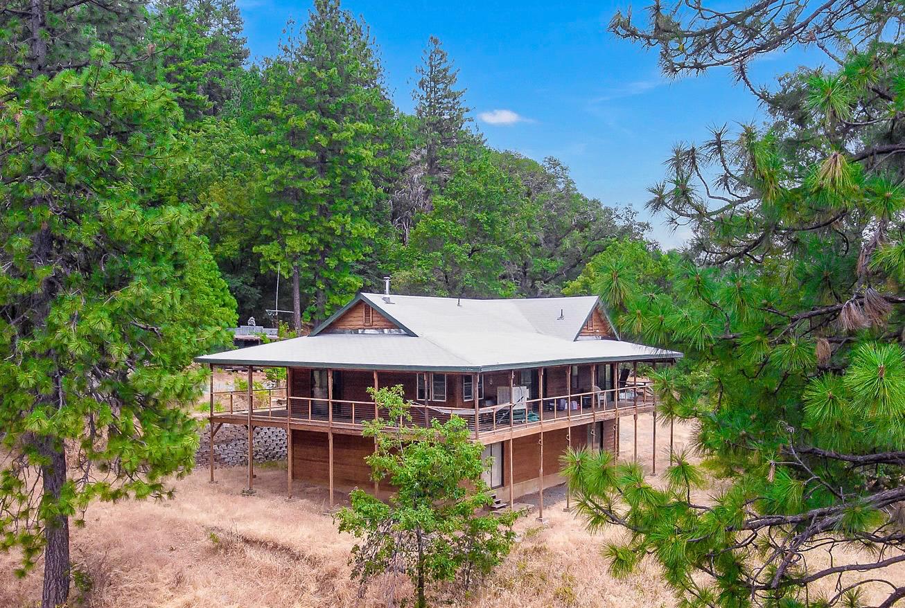 an aerial view of a house with yard and balcony
