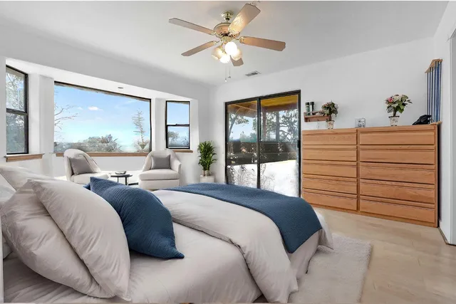 a bedroom with a large bed and a large window