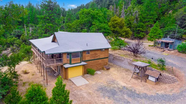 an aerial view of a house with garden space and sitting area