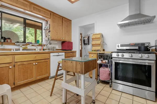 a kitchen with a stove a sink and a microwave