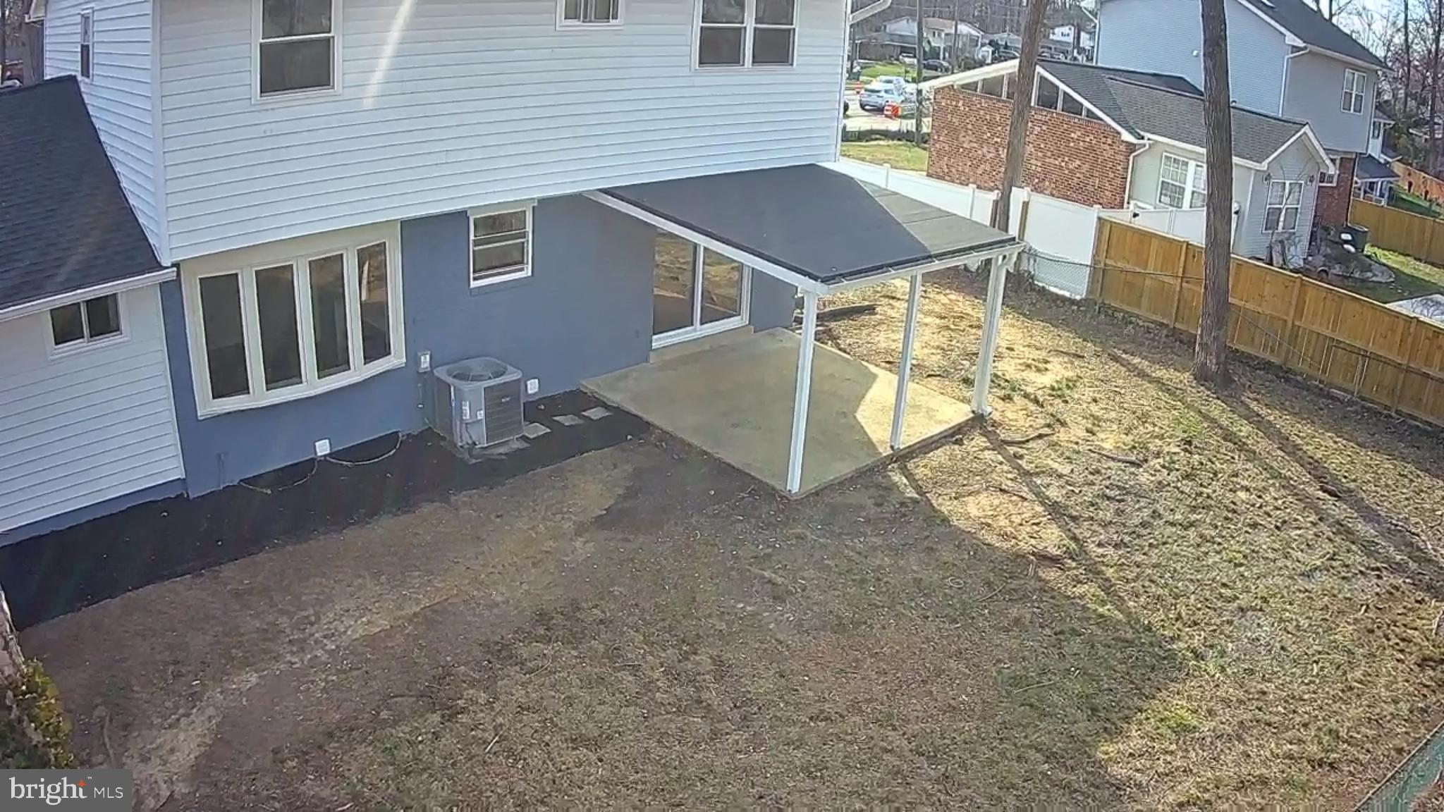 6815 Rolling Road Springfield, VA 22152 - Photo 16 of 40 a view of a house with backyard and porch