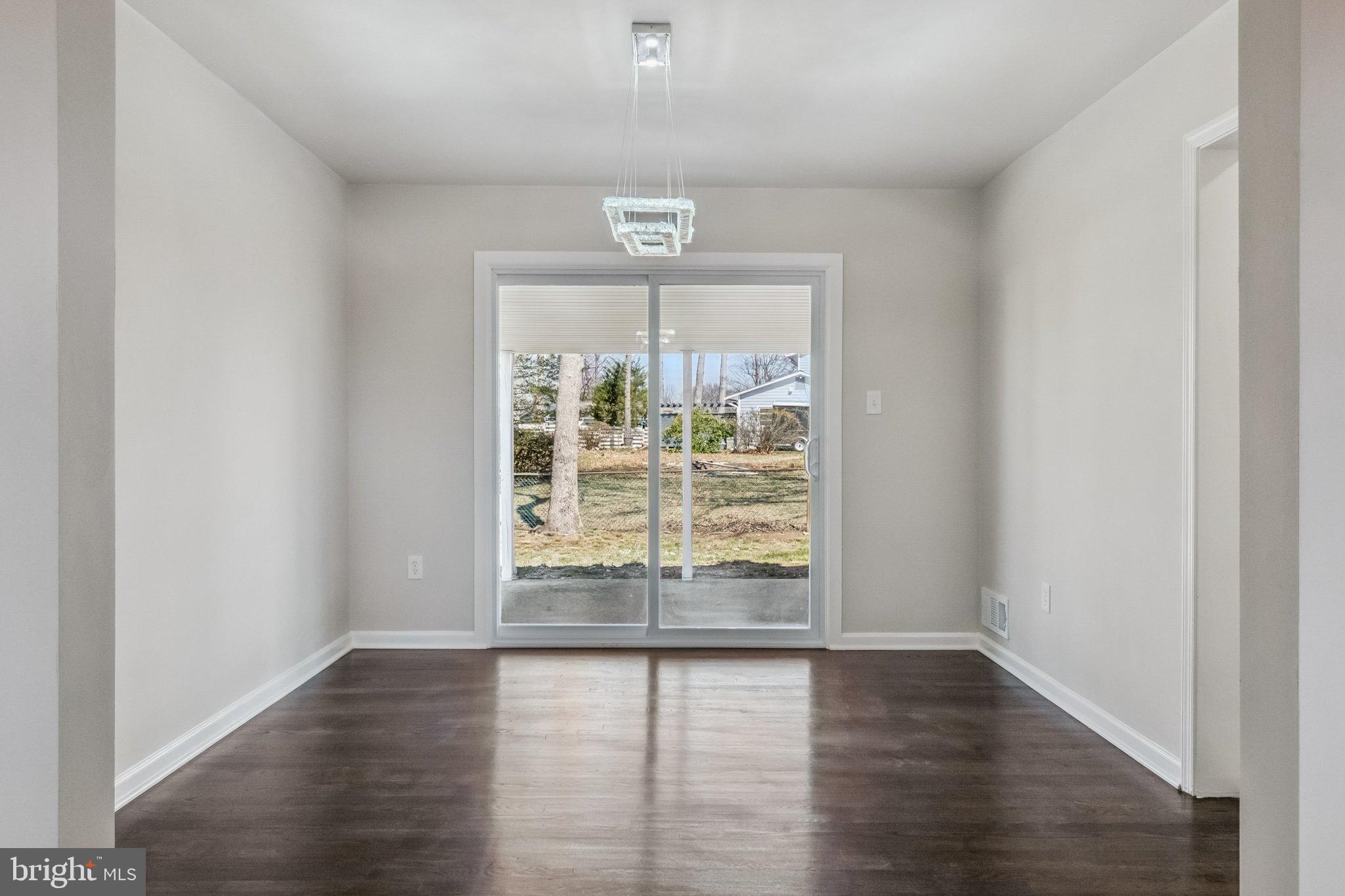 6815 Rolling Road Springfield, VA 22152 - Photo 29 of 40 an empty room with wooden floor and windows
