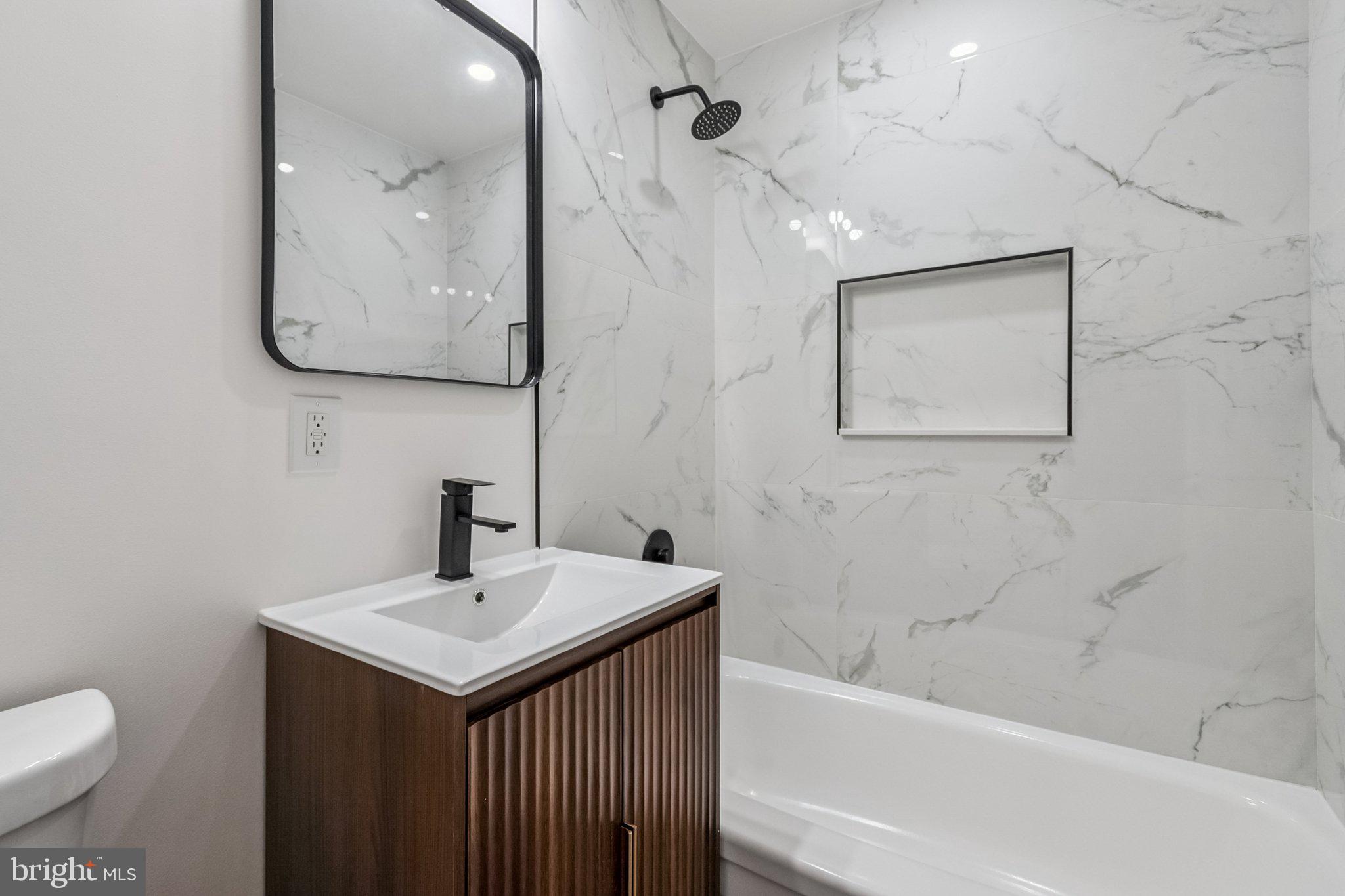 6815 Rolling Road Springfield, VA 22152 - Photo 31 of 40 a bathroom with a sink and a mirror