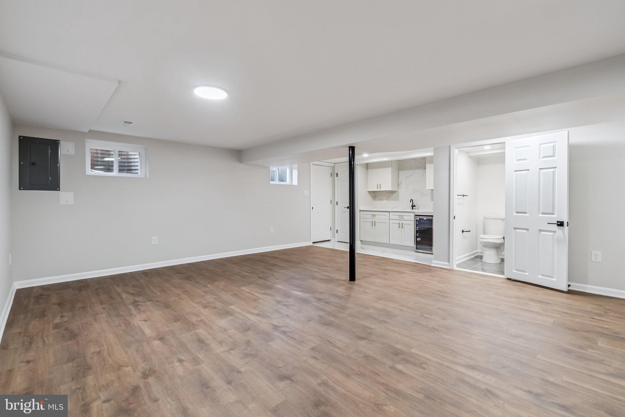 6815 Rolling Road Springfield, VA 22152 - Photo 39 of 40 a view of an empty room with wooden floor and a window