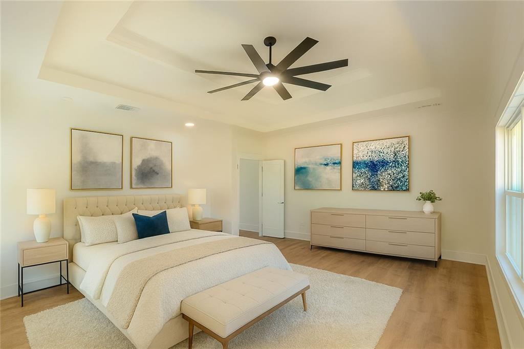 1271 Ga-138 Monroe, GA 30655 - Photo 24 of 40 a bedroom with a large bed and a chandelier