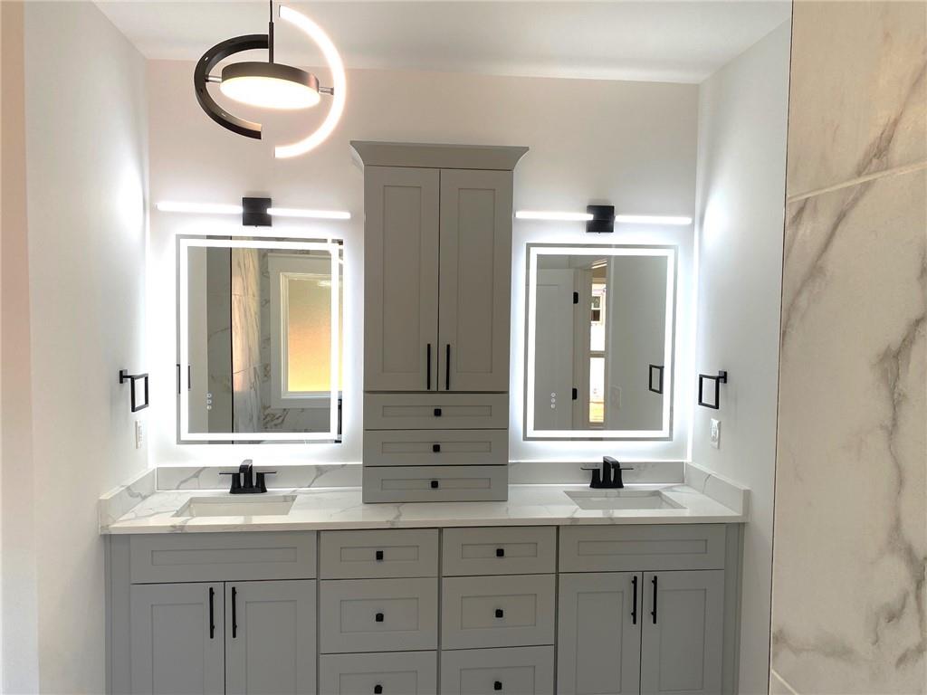 1271 Ga-138 Monroe, GA 30655 - Photo 28 of 40 a bathroom with a granite countertop sink and a mirror