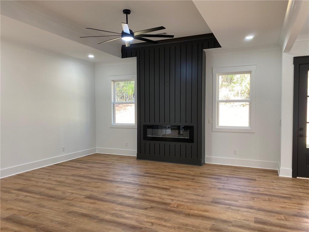 1271 Ga-138 Monroe, GA 30655 - Photo 9 of 40 a view of empty room with wooden floor and fan
