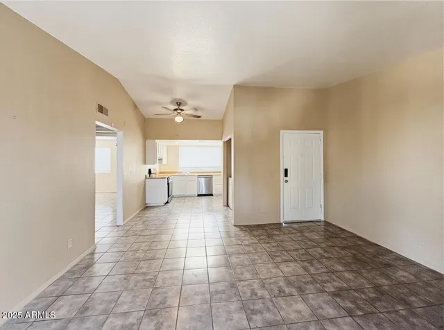 a view of a big room with closet and windows