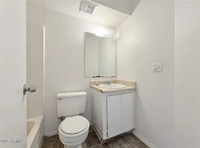 a bathroom with a sink toilet and a mirror