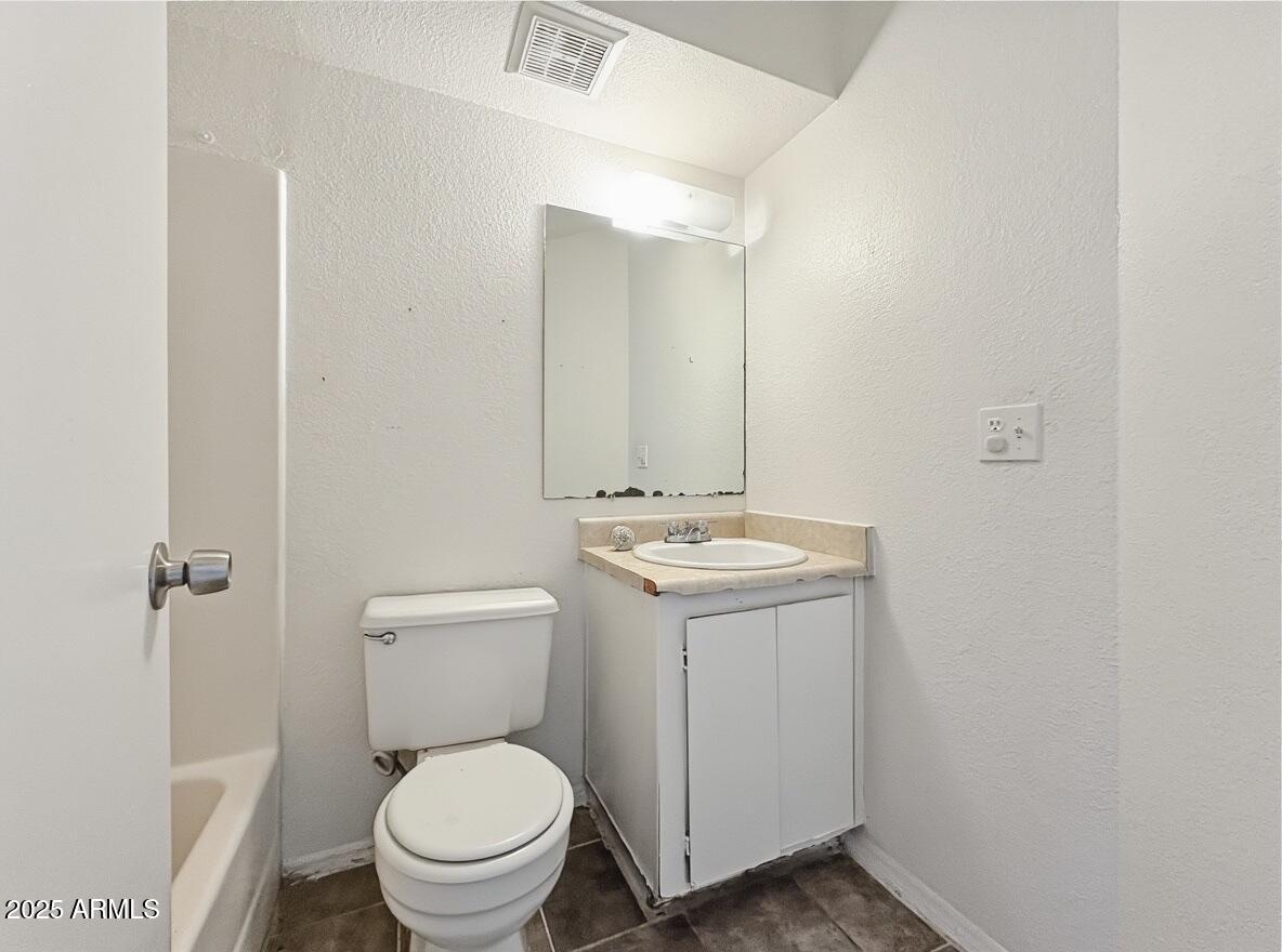 10820 North 16th Avenue, Unit 4 Phoenix, AZ 85029 - Photo 7 of 11 a bathroom with a sink toilet and a mirror