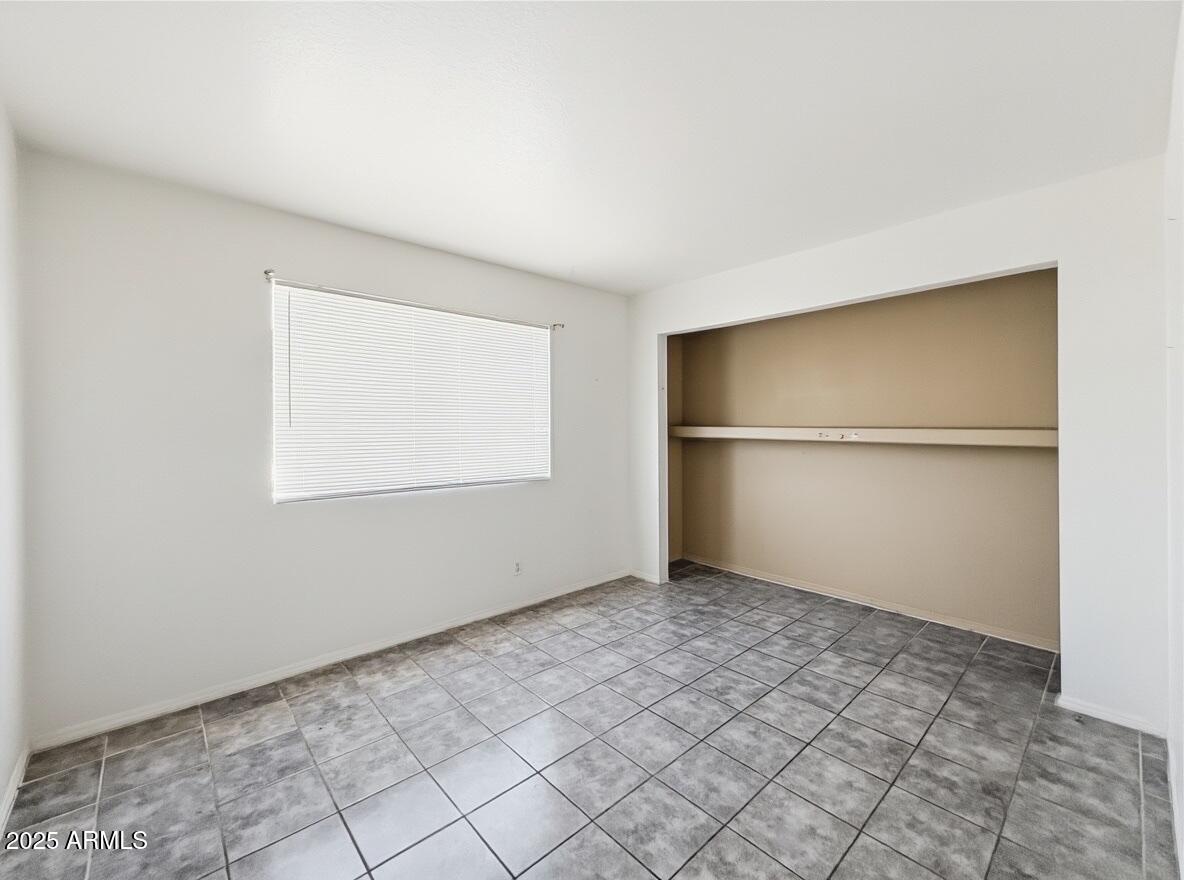 10820 North 16th Avenue, Unit 4 Phoenix, AZ 85029 - Photo 8 of 11 a view of an empty room with a window