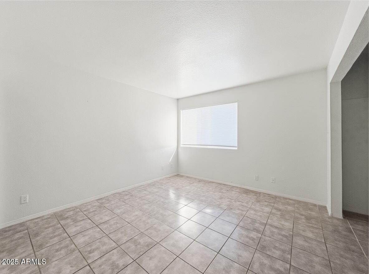 10820 North 16th Avenue, Unit 4 Phoenix, AZ 85029 - Photo 9 of 11 an empty room with windows