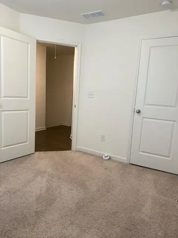 an empty room with closet area