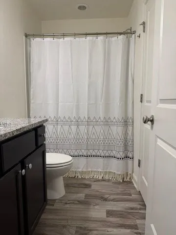 a bathroom with a toilet and a shower