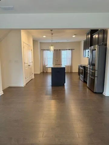 a view of kitchen with refrigerator and window