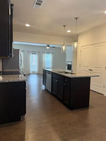 a view of a kitchen counter top space with stainless steel appliances granite countertop cabinets and a counter top space