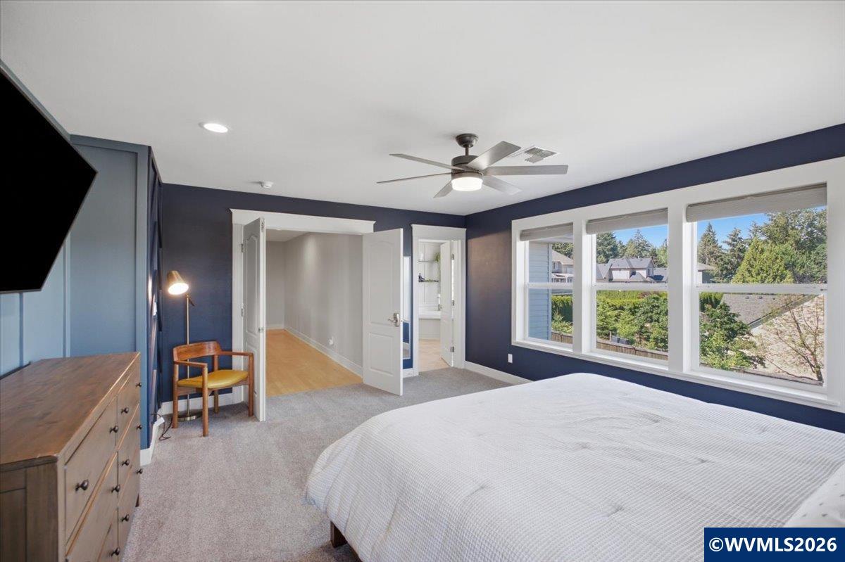 1492 Northwest Penny Lane Albany, OR 97321 - Photo 29 of 50 a spacious bedroom with a large bed and a large window