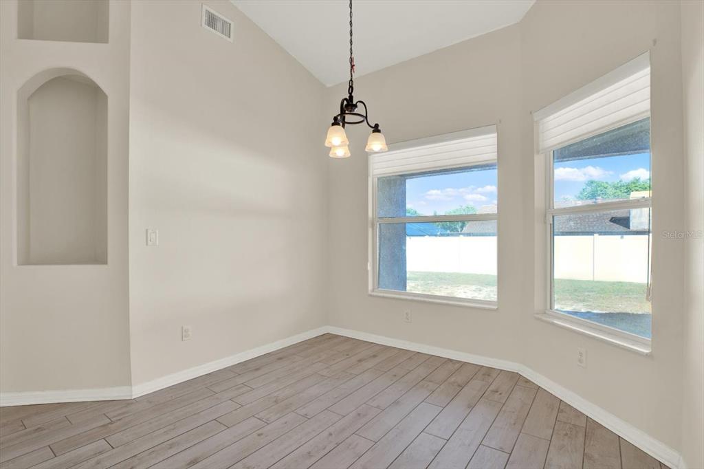 4400 Dior Road Spring Hill, FL 34609 - Photo 18 of 37 a view of an empty room with wooden floor and a window