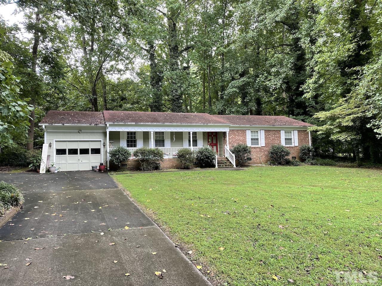 401 Andover Road Durham, NC 27712 - Photo 1 of 15 a front view of a house with a garden