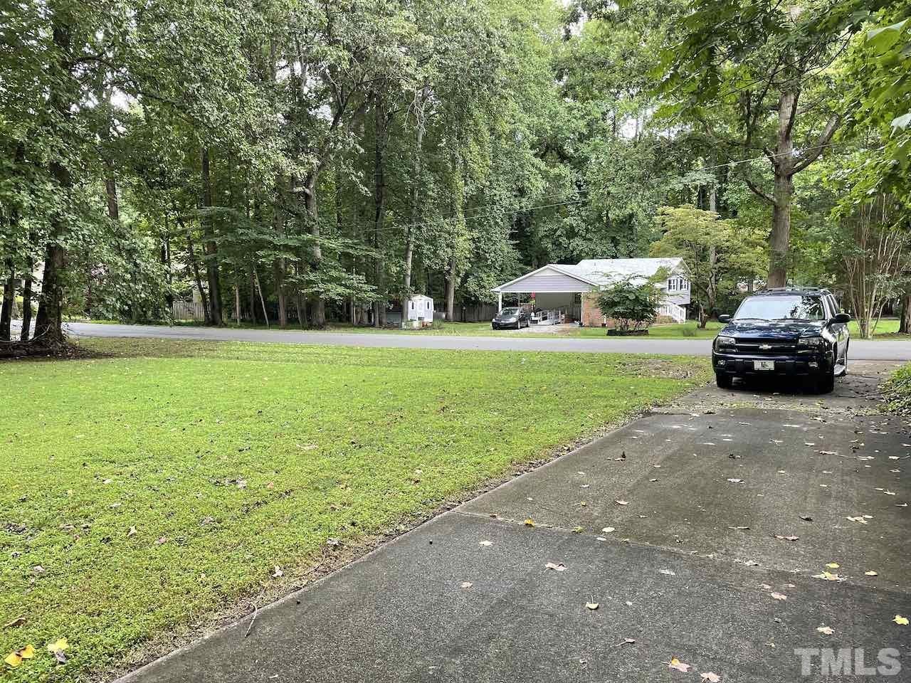 401 Andover Road Durham, NC 27712 - Photo 4 of 15 a car parked in the middle of a park with large trees