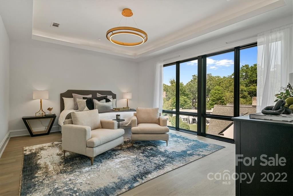 610 Queens Road Charlotte, NC 28207 - Photo 29 of 38 a bedroom with furniture and a large window