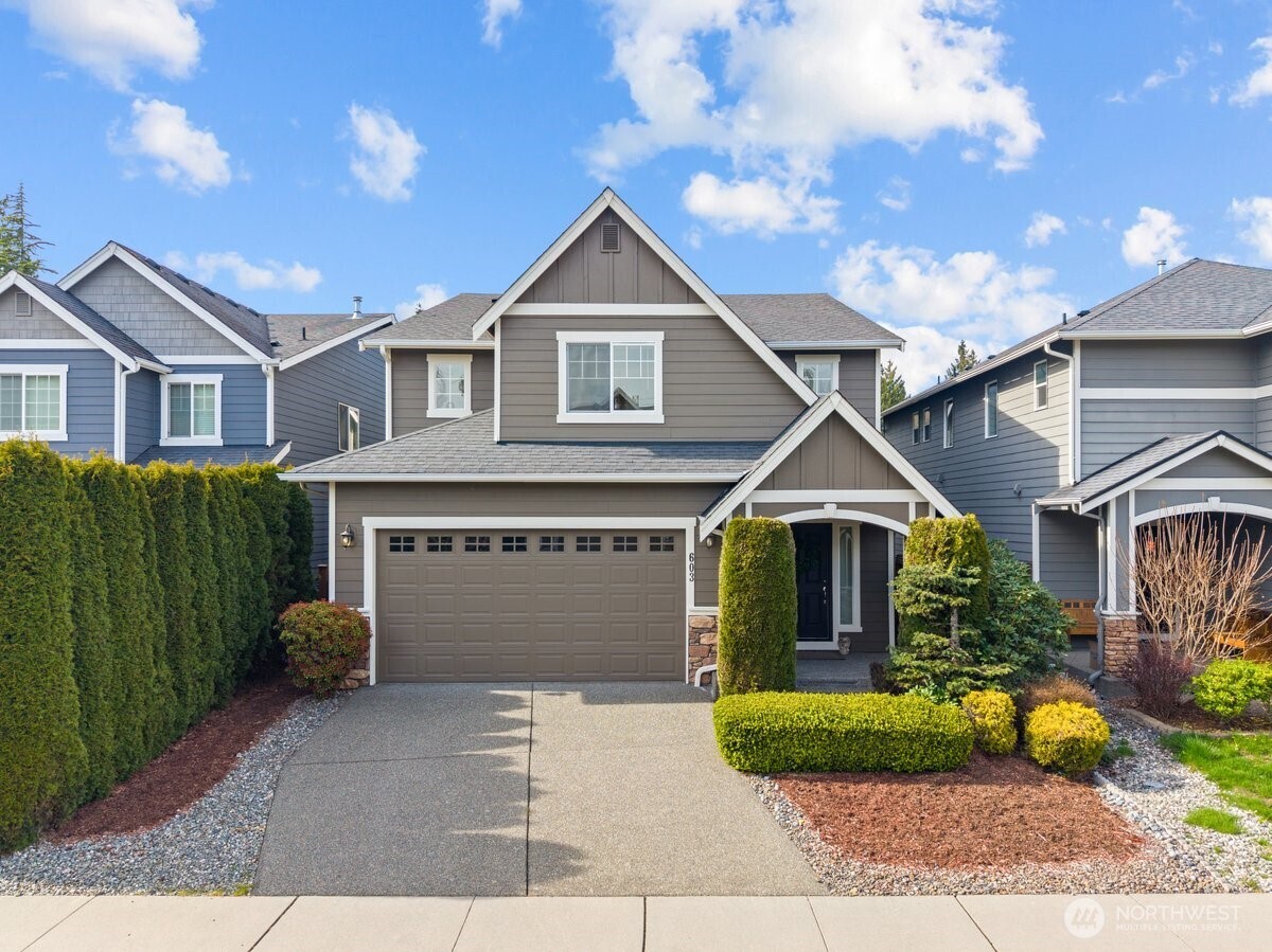 a front view of a house with a yard and garage