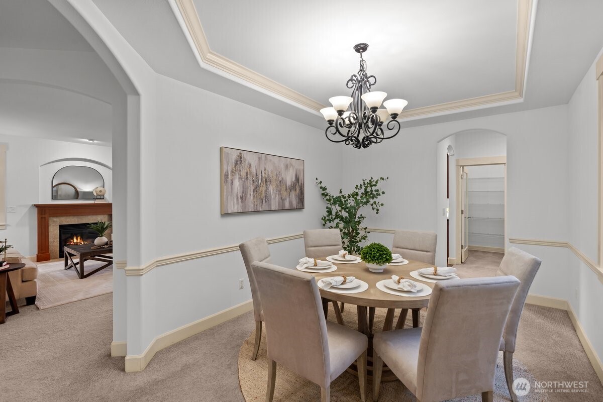 603 194th Place Southeast Bothell, WA 98012 - Photo 12 of 30 a dining room with furniture a chandelier and a mirror