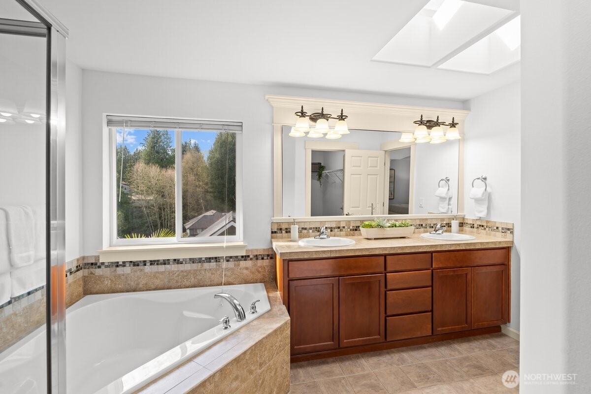 603 194th Place Southeast Bothell, WA 98012 - Photo 20 of 30 a bathroom with a tub a sink and mirror